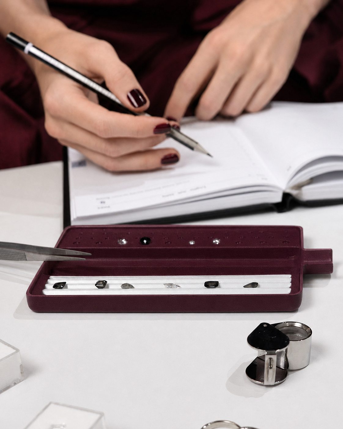 A jewellery consultation with loose gemstones and design notes
