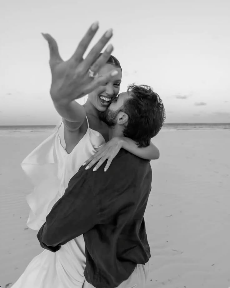 A couple celebrating their engagement on the beach