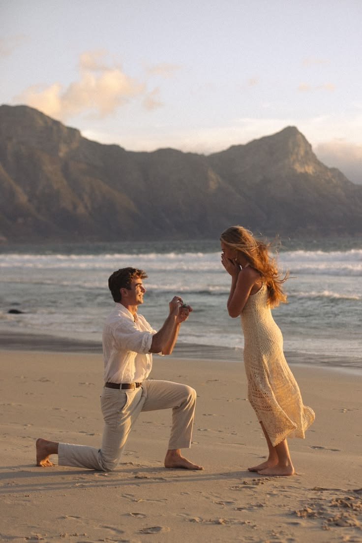 A marriage proposal on a beach at sunset