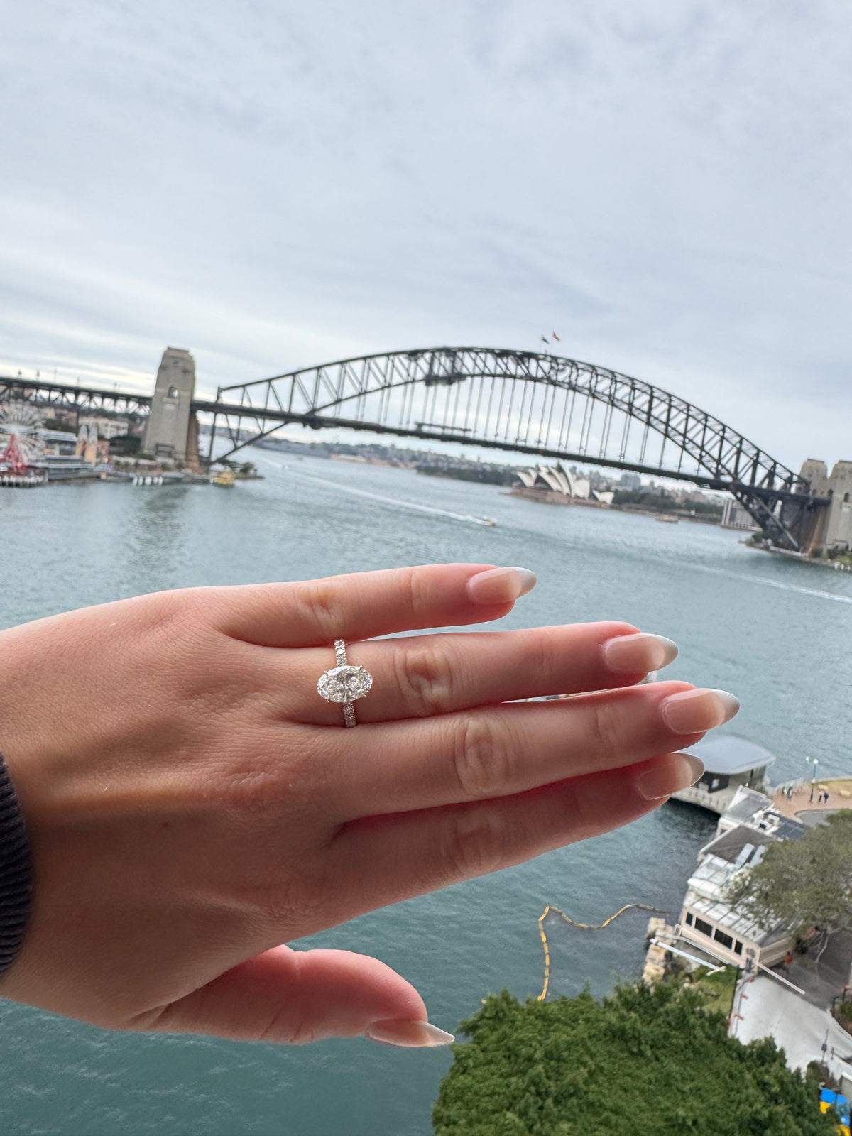 Oval diamond pavé engagement ring with Sydney Harbour in the background